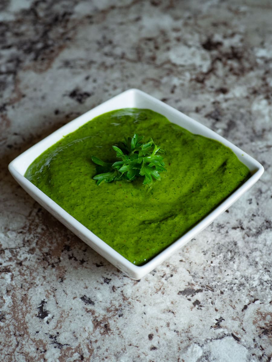 Bowl of Chimichurri sauce garnished with parsley.