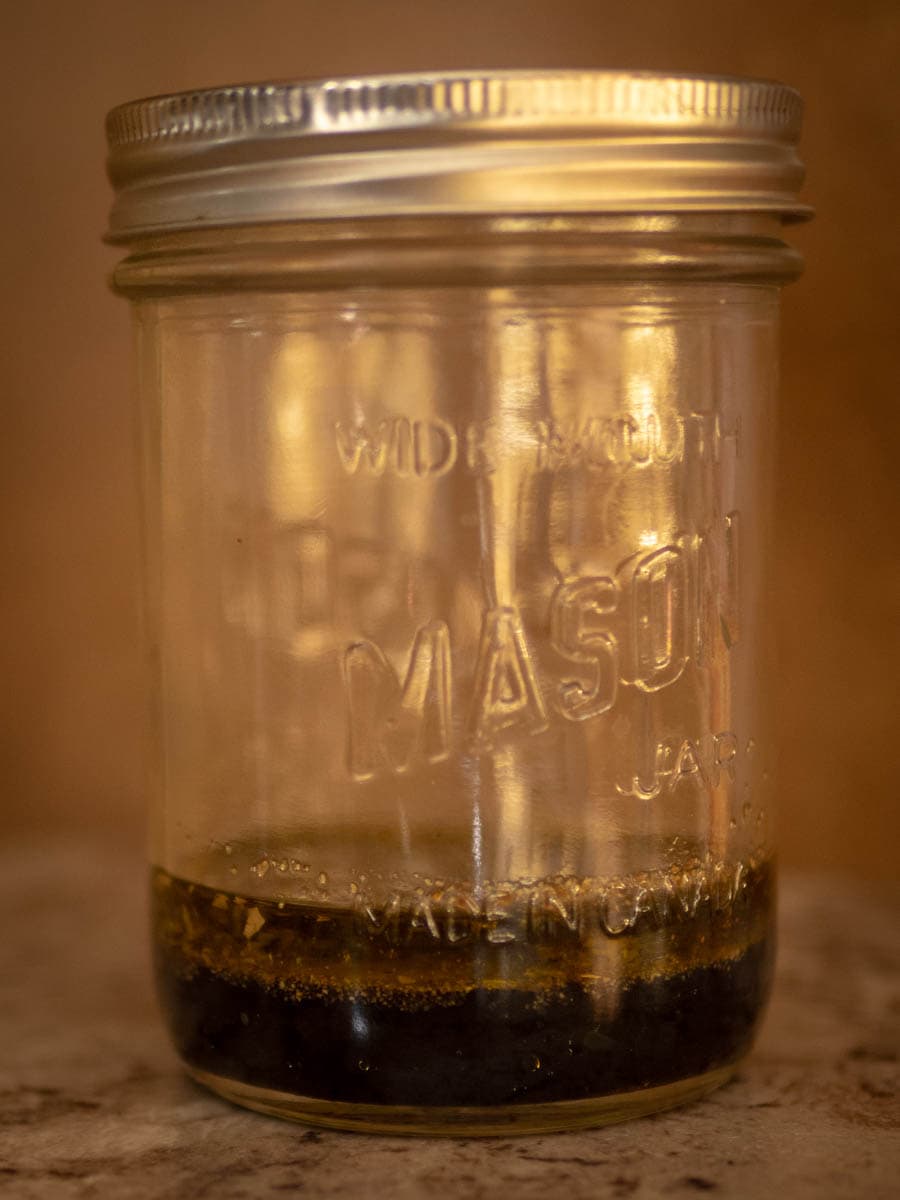 Mason jar with vinegar and oil.