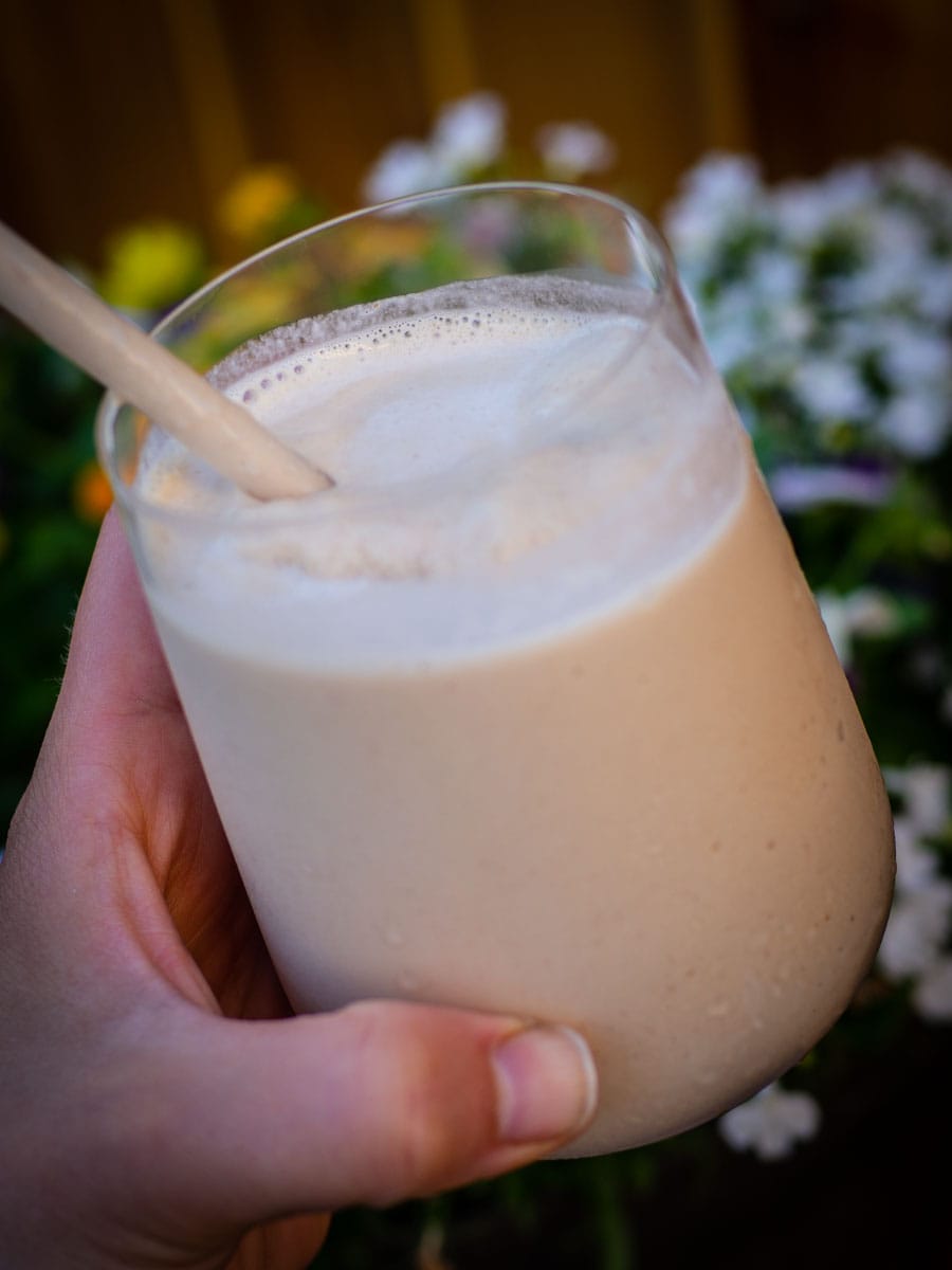 Chai Frappe with flowers in the background.