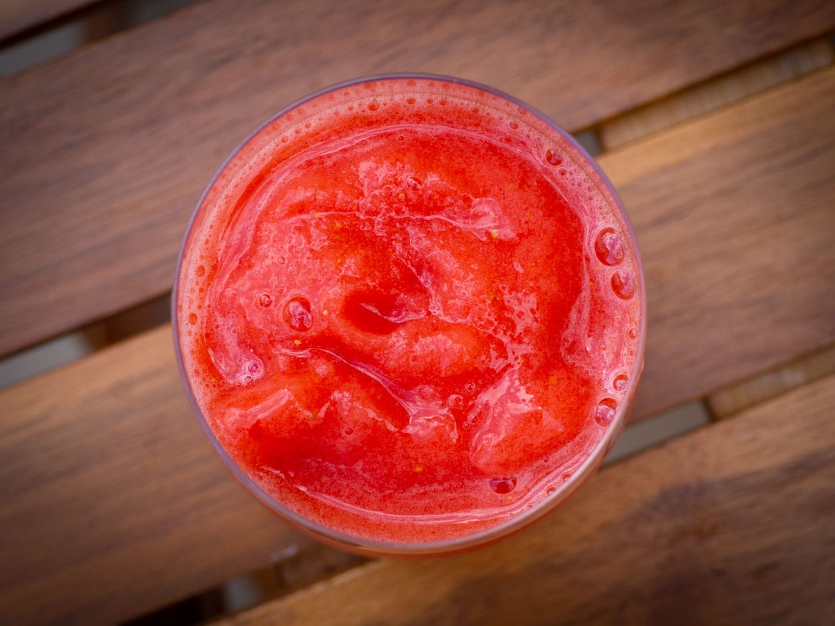 Top view of a glass of frozen strawberry lemonade.