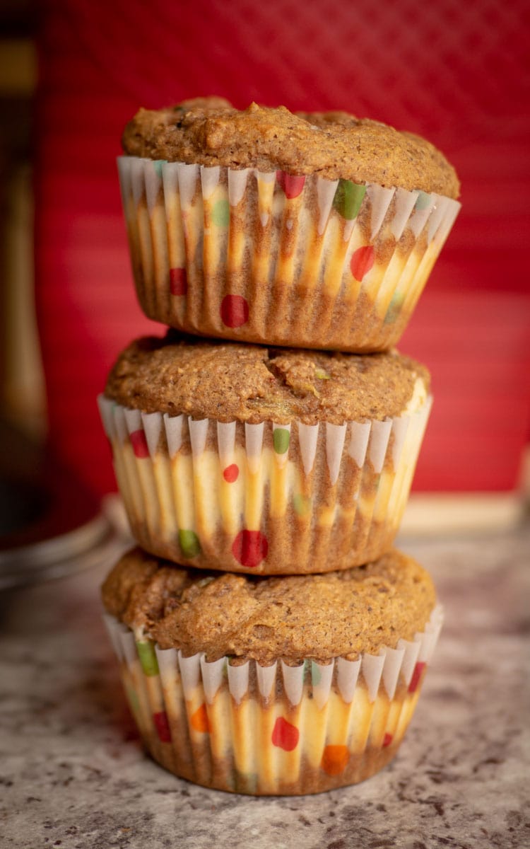 Honey Spice Zucchini Muffins with cheesecake filling stacked.