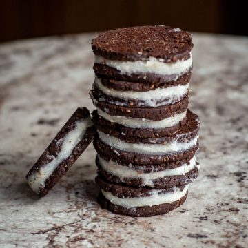 Stack of homemade oreo-inspired cookies on a countertop.