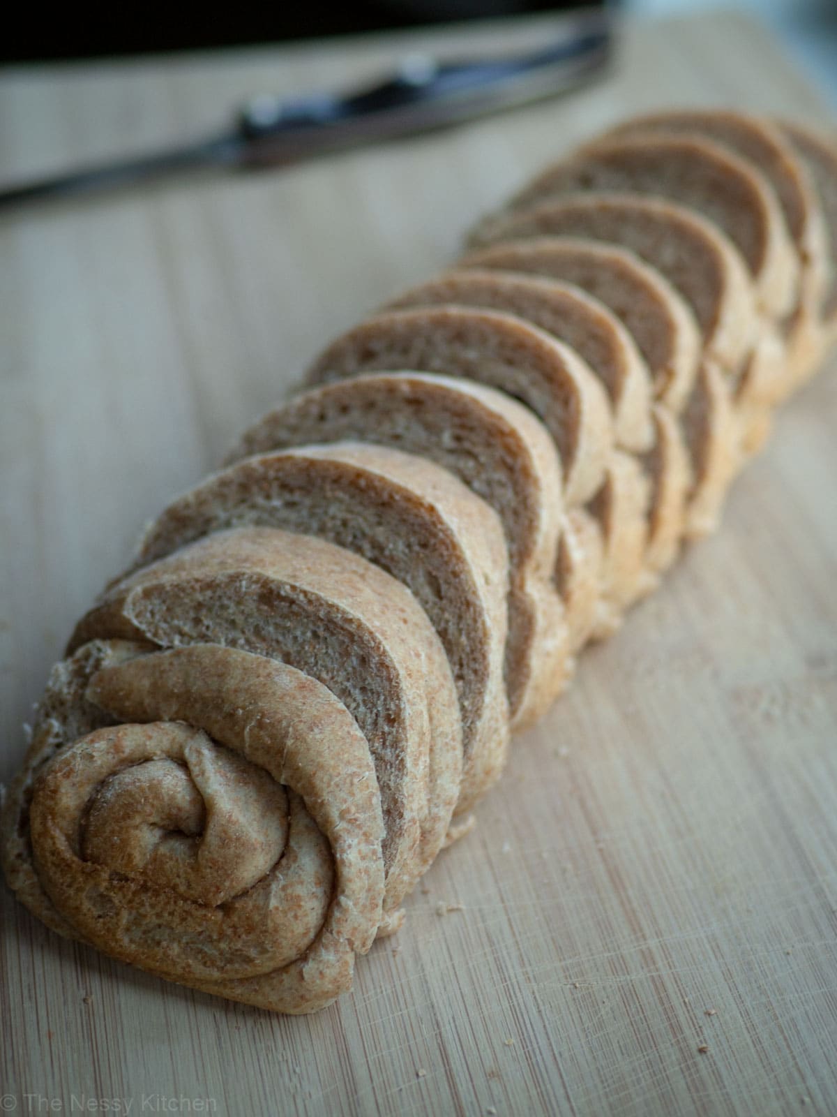 Sliced honey oat bread on a cutting board.