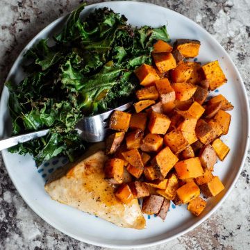 Plate of sweet potatoes, kale and chicken.
