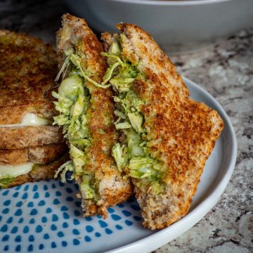 Chicken and Chimichurri sandwich with melted cheese on a plate.