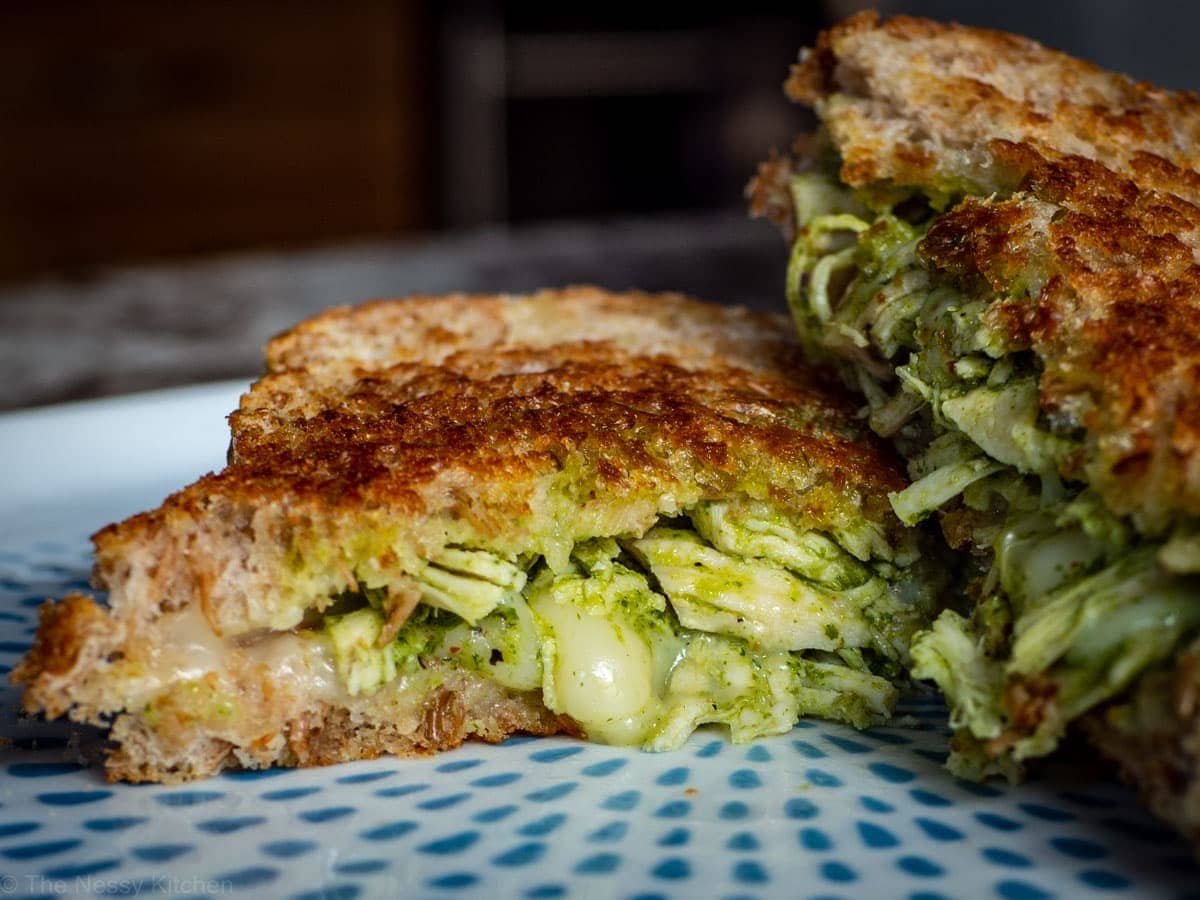 Close up shot of grilled cheese sandwich with chicken showing melted cheese.