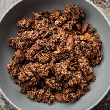 Chocolate granola in grey bowl.