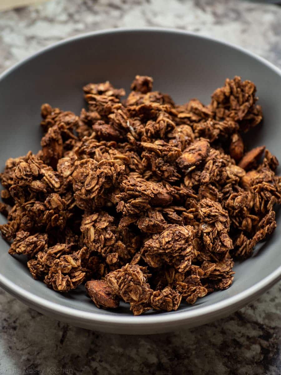 A grey bowl filled with chocolate granola.