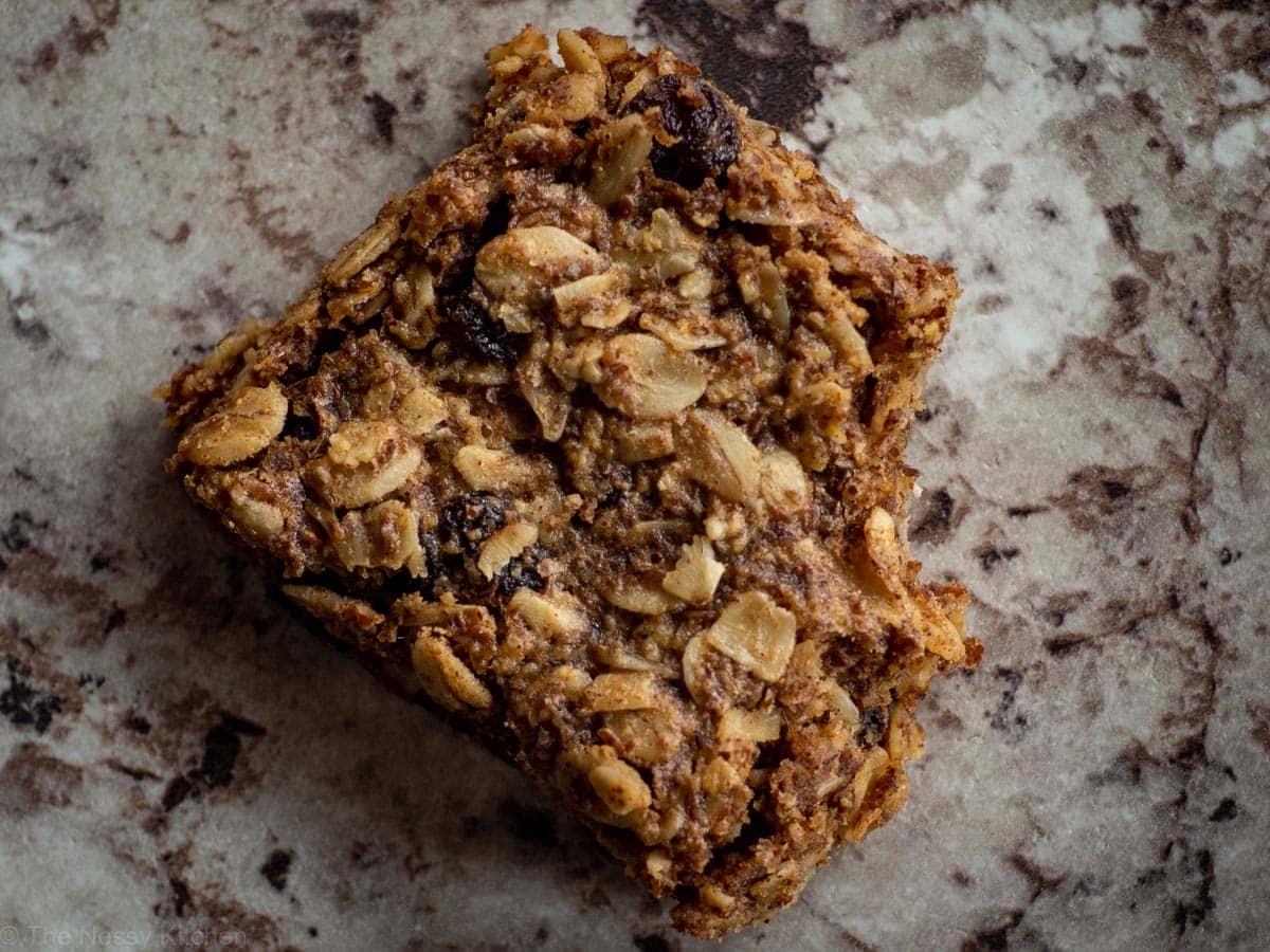 Oatmeal cookie bar with a bite taken out.