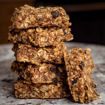 Oatmeal cookie squares stacked in a pile.