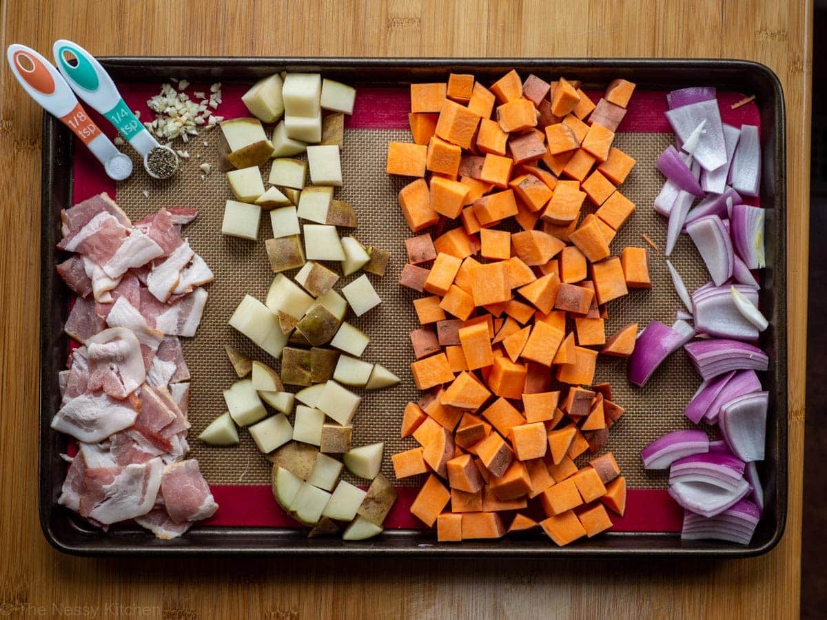 Picture of ingredients for recipe. Bacon, potatoes, sweet potatoes, red onions and seasoning.