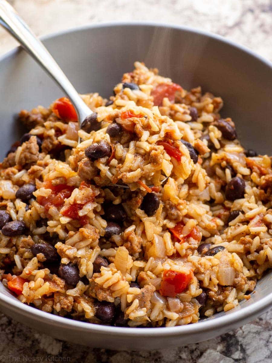 Chorizo Rice and Beans in a bowl with a spoon.