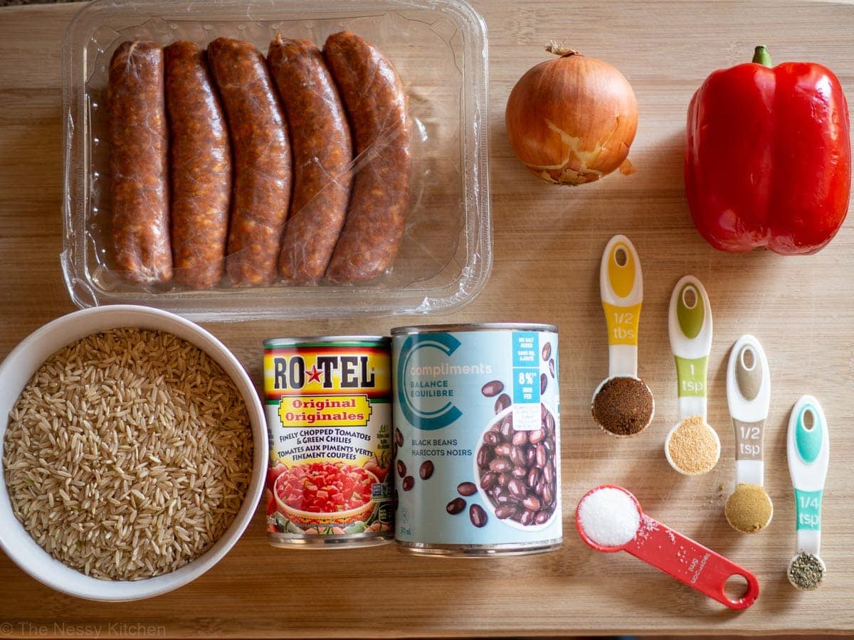 Ingredients for Chorizo and Rice Skillet on a wooden cutting board.