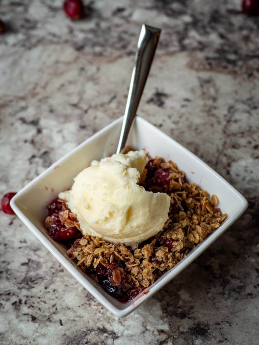 Cranberry Crisp topped with ice cream.
