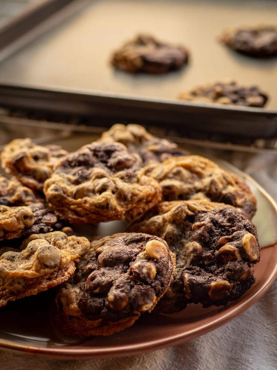 Plate of half and half cookies with sheet pan in the background.