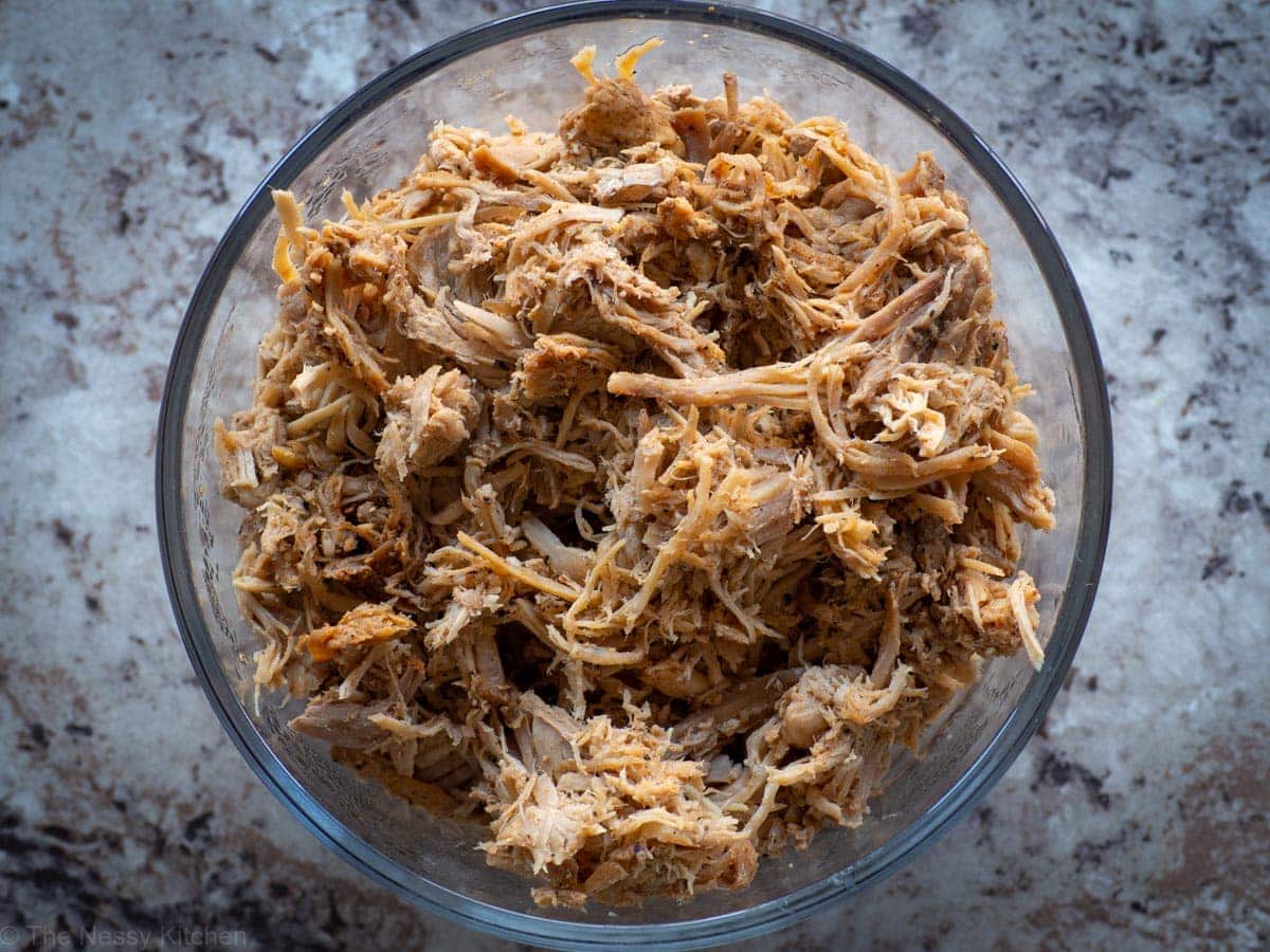 Pulled pork in a glass bowl.