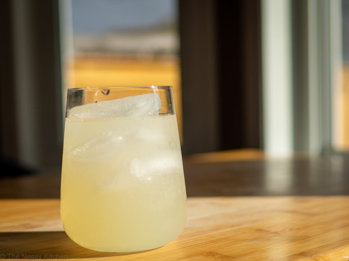 Glass of lemonade one a wooden surface.