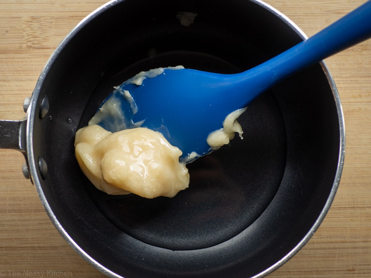 Mixing together ingredients in a pot.