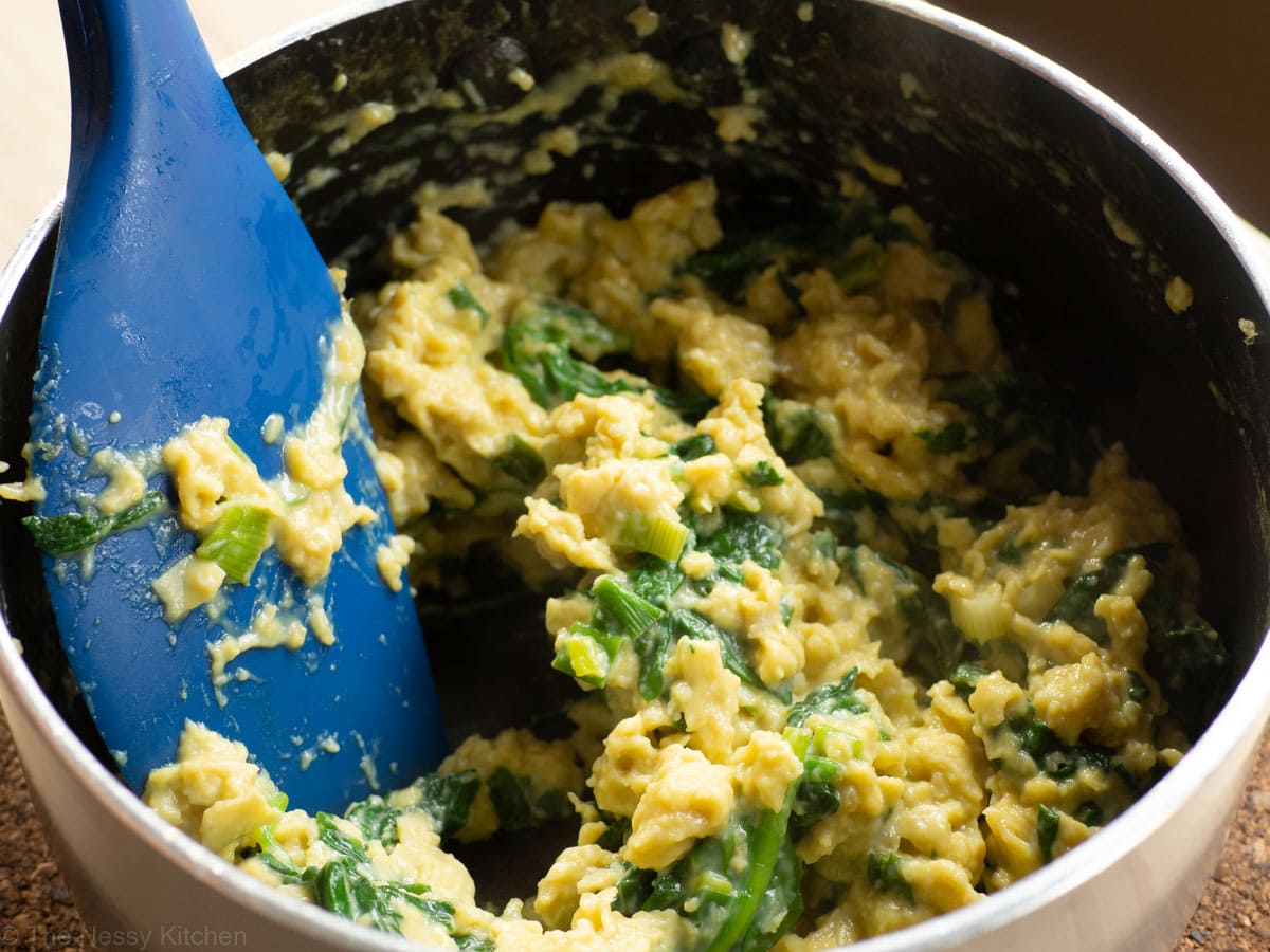 Chinese inspired scrambled eggs being cooked in a pot.