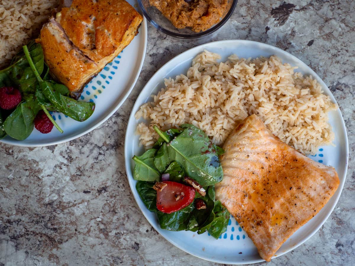 Top view of plates with salmon and rice.