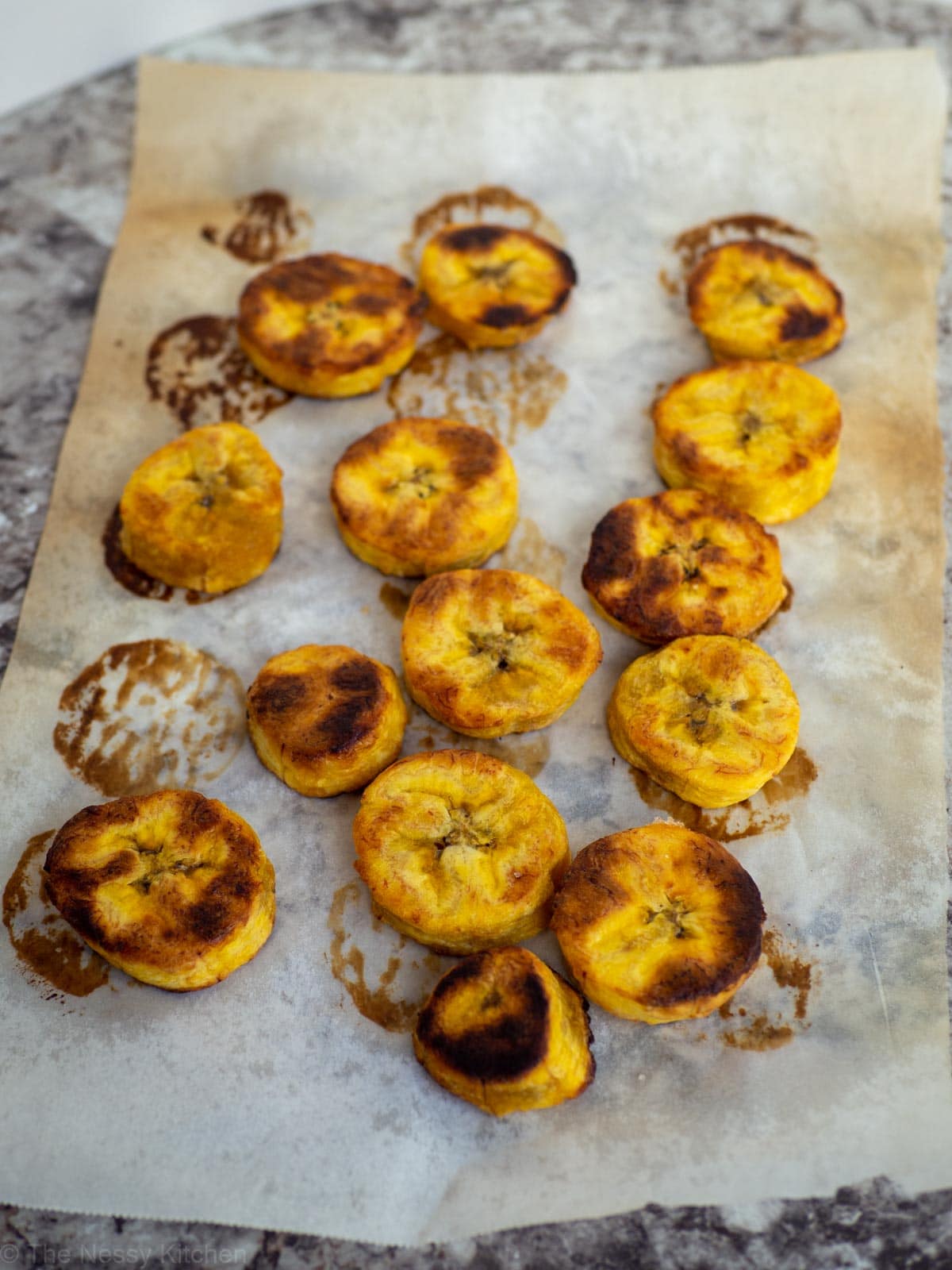 Baked sweet plantains on parchment paper.