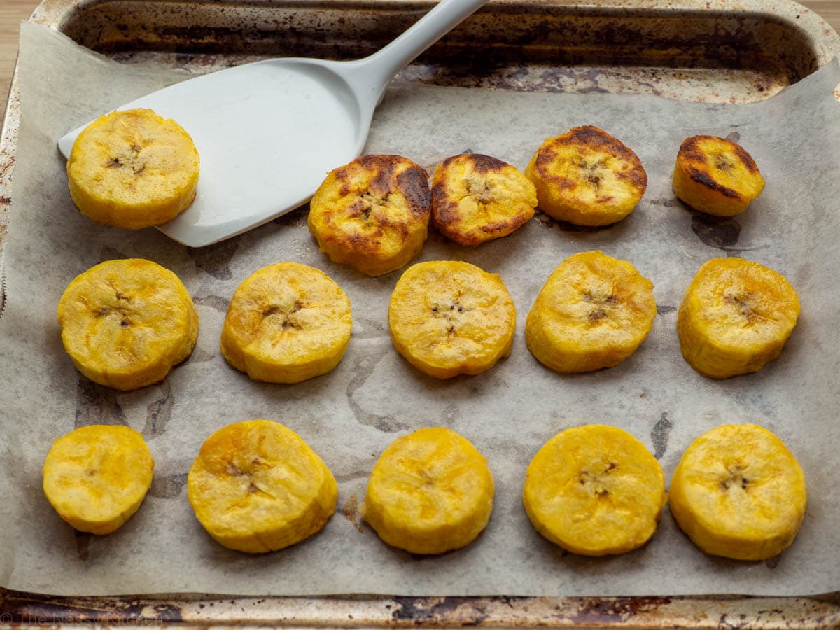 Ripe plantain rounds that are half done cooking and are crisp on the bottom.
