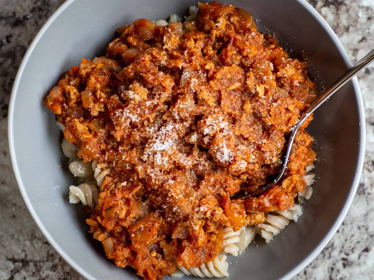 Bowl of tomato meat sauce on pasta.