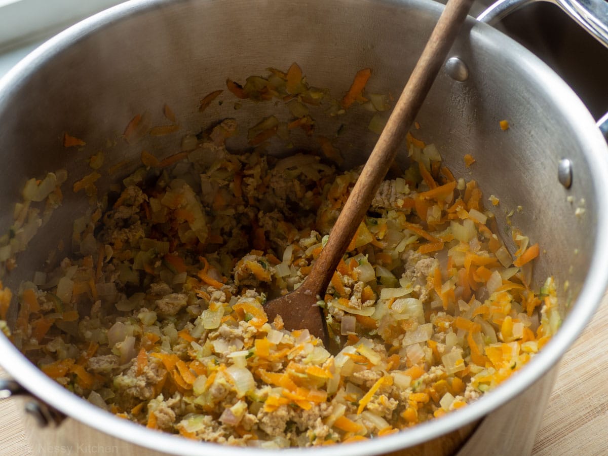 Turkey browned in pot with vegetables.