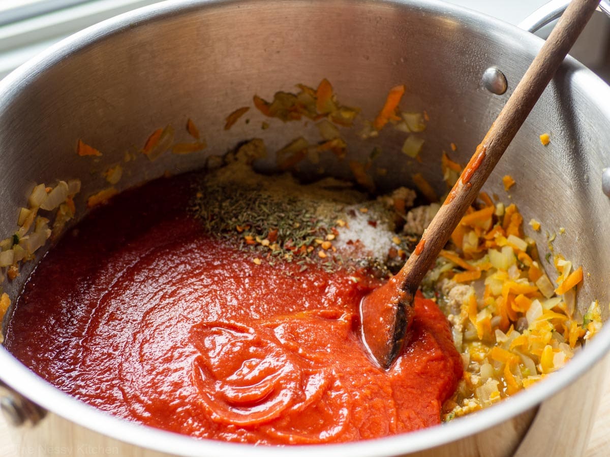 Tomatoes and seasonings added to pot with turkey and vegetables.