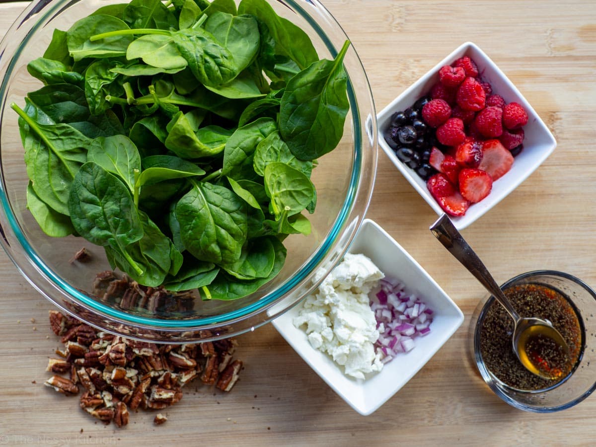 Ingredients for spinach salad with frozen berries.