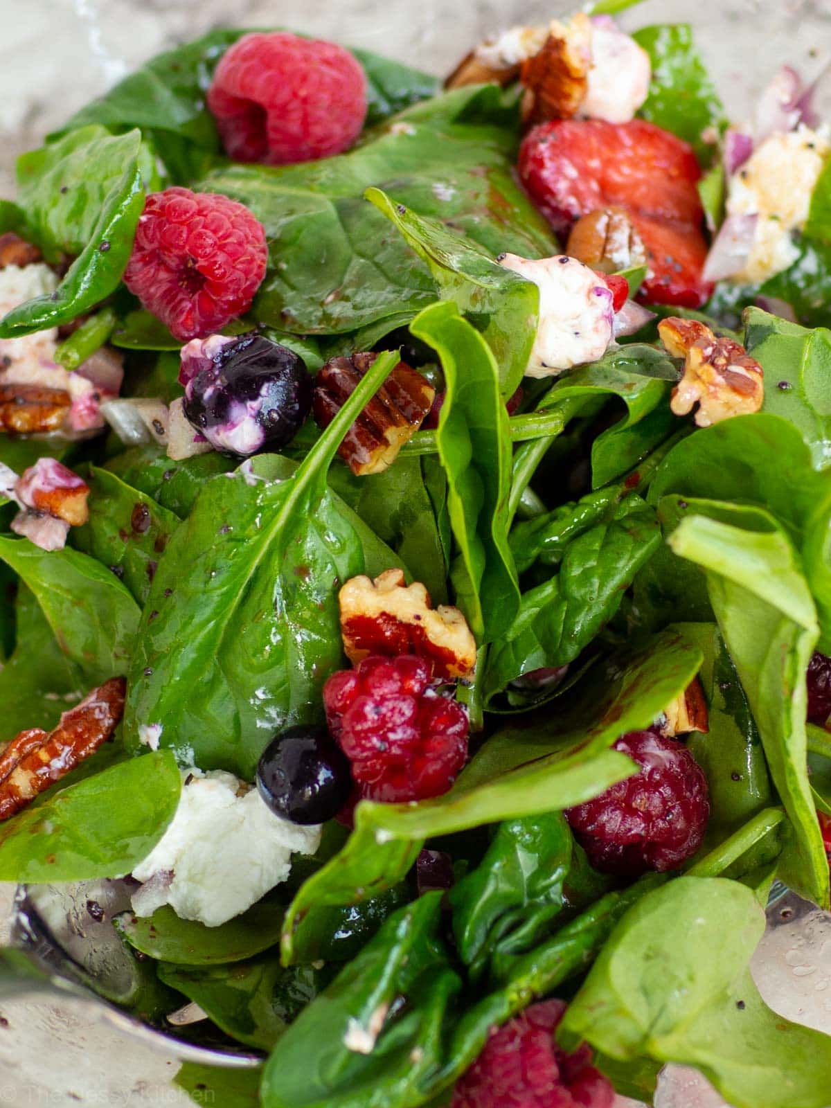 Close up shot of mixed berry spinach salad.