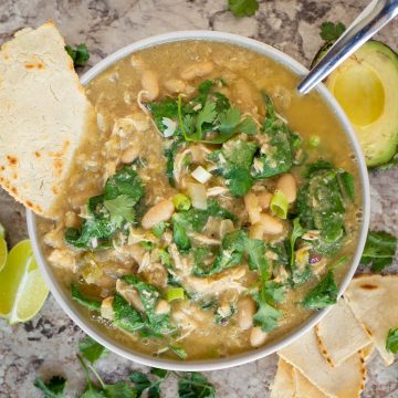 Bowl of white chicken chili topped with cilantro.