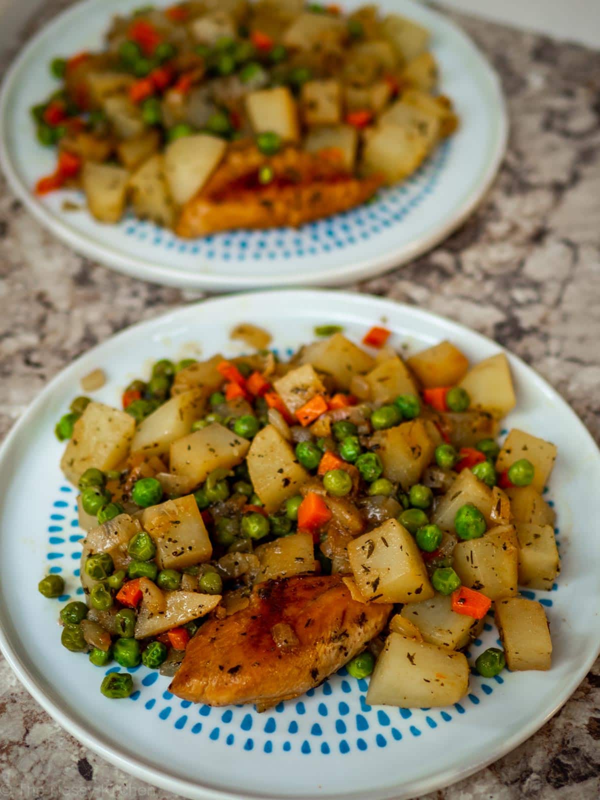 Plate of potatoes, chicken and vegetables.