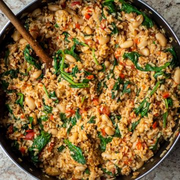 Skillet with sausage, rice and vegetables cooked together.