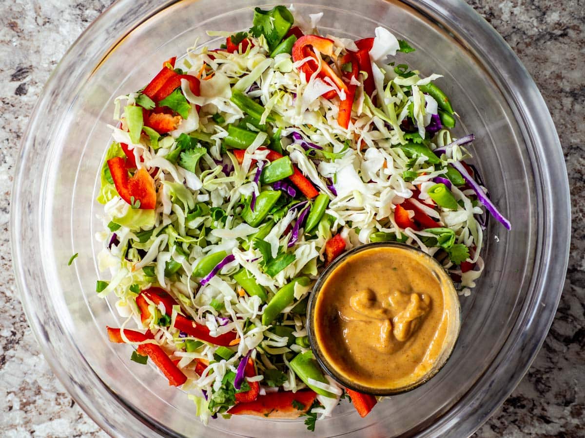 Vegetables mixed together in a large bowl before adding dressing.