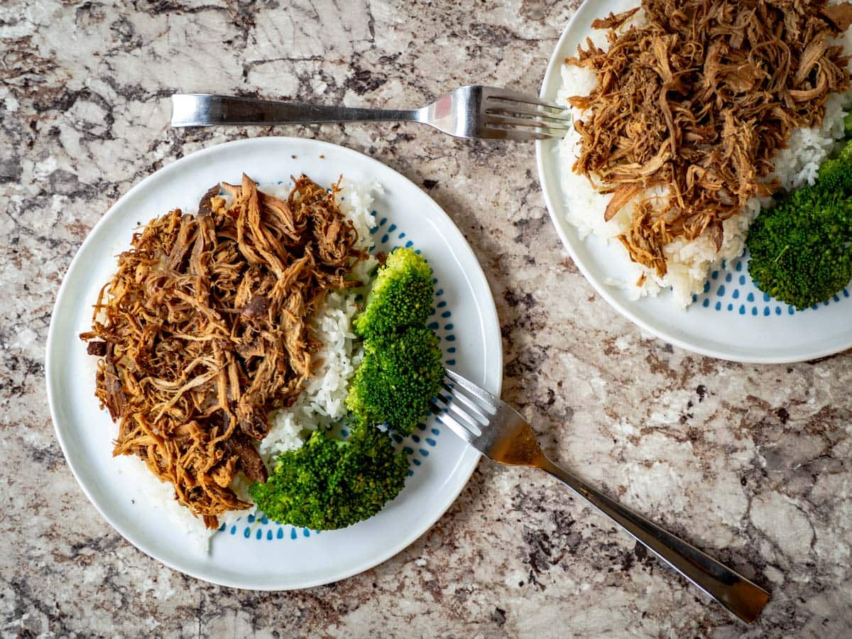 Char siu shredded pork on a bed of rice with broccoli.