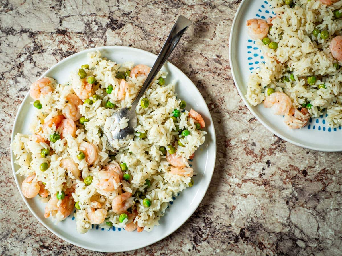 Two plates of lemon herb shrimp and rice.