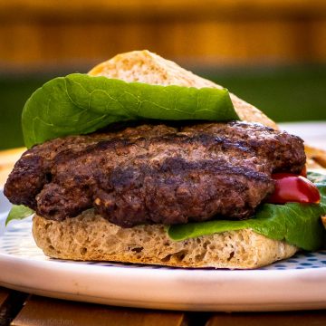 Burger in a bun on a plate.