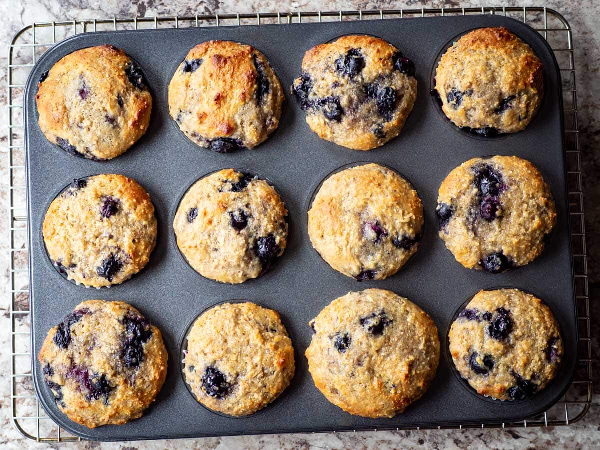 Tray of blueberry muffins that have been baked.