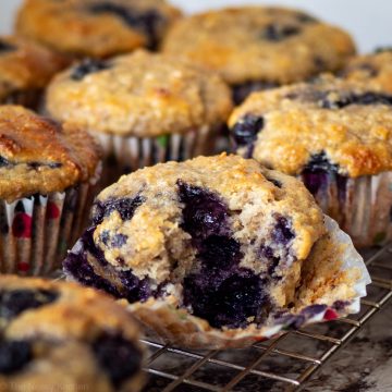 Blueberry oat muffin with a bite taken out of it.