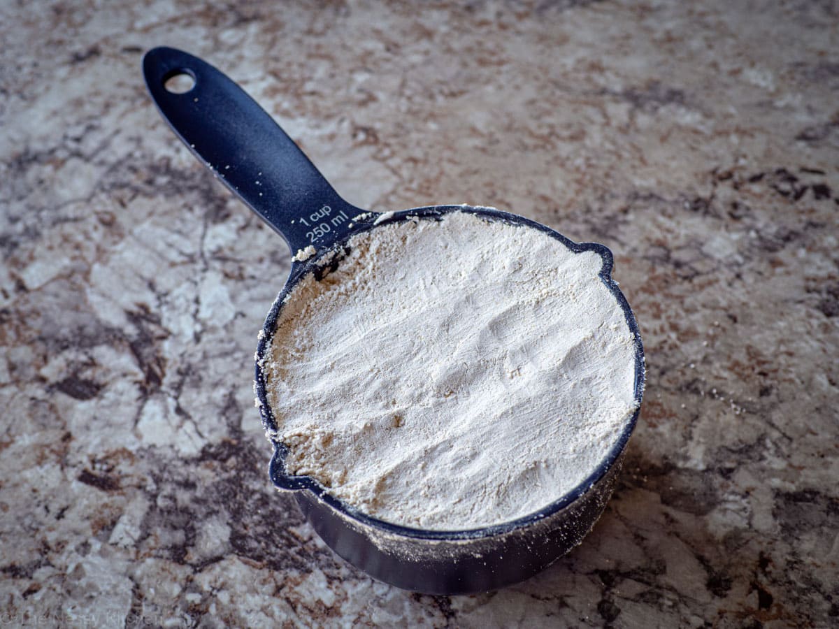 Picture of a measuring cup that has been filled with lightly packed oat flour and levelled off.