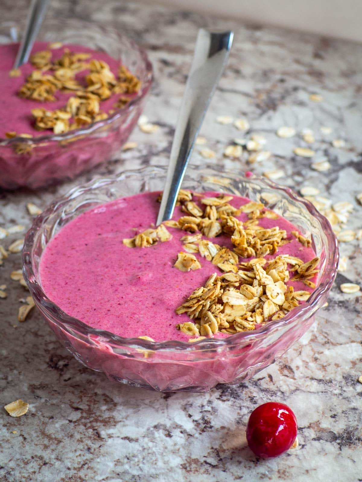 Picture of pink smoothie bowl topped with granola.