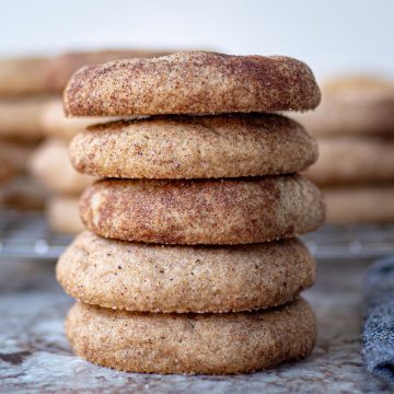 Snickerdoodle cookies stacked on top of one another.