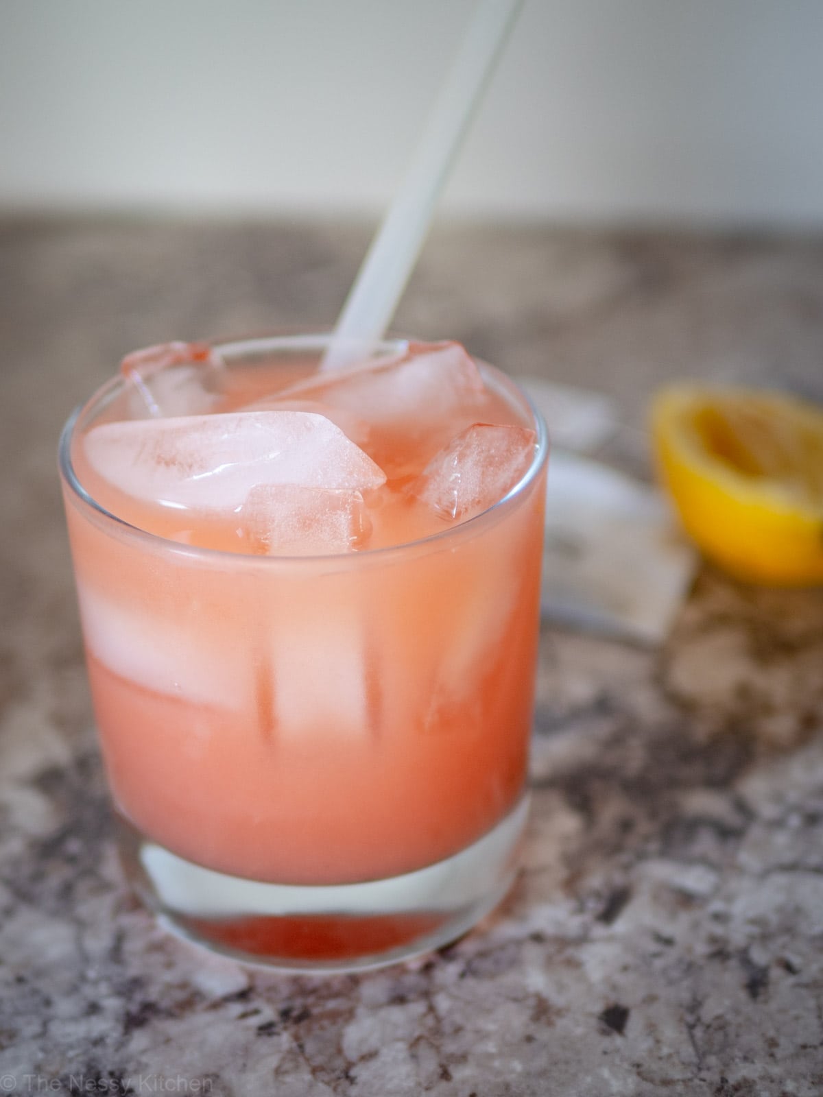 White Tea Guava Lemonade in a cup with a straw.