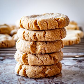 Stack of peanut butter cookies on a countertop.