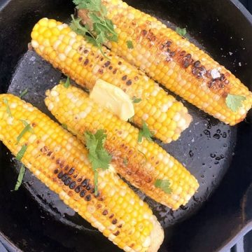 Corn on the cob in a skillet.