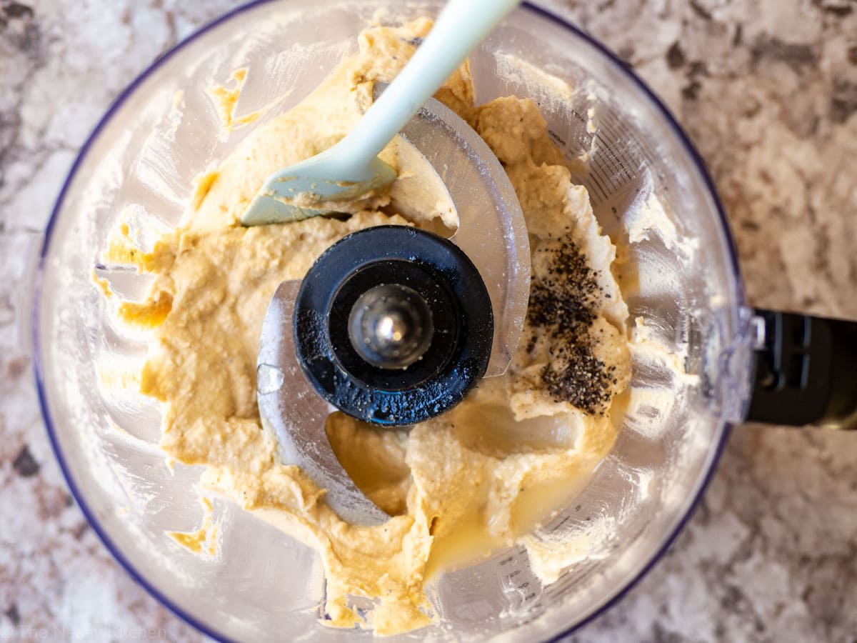 Extra salt and pepper placed in a food processor with hummus mixture.