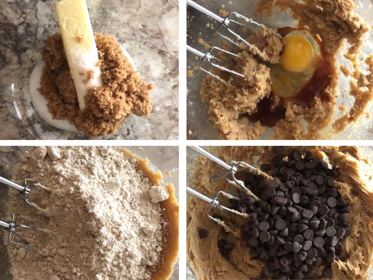 Cookie batter being mixed in a glass bowl with an electric mixer.