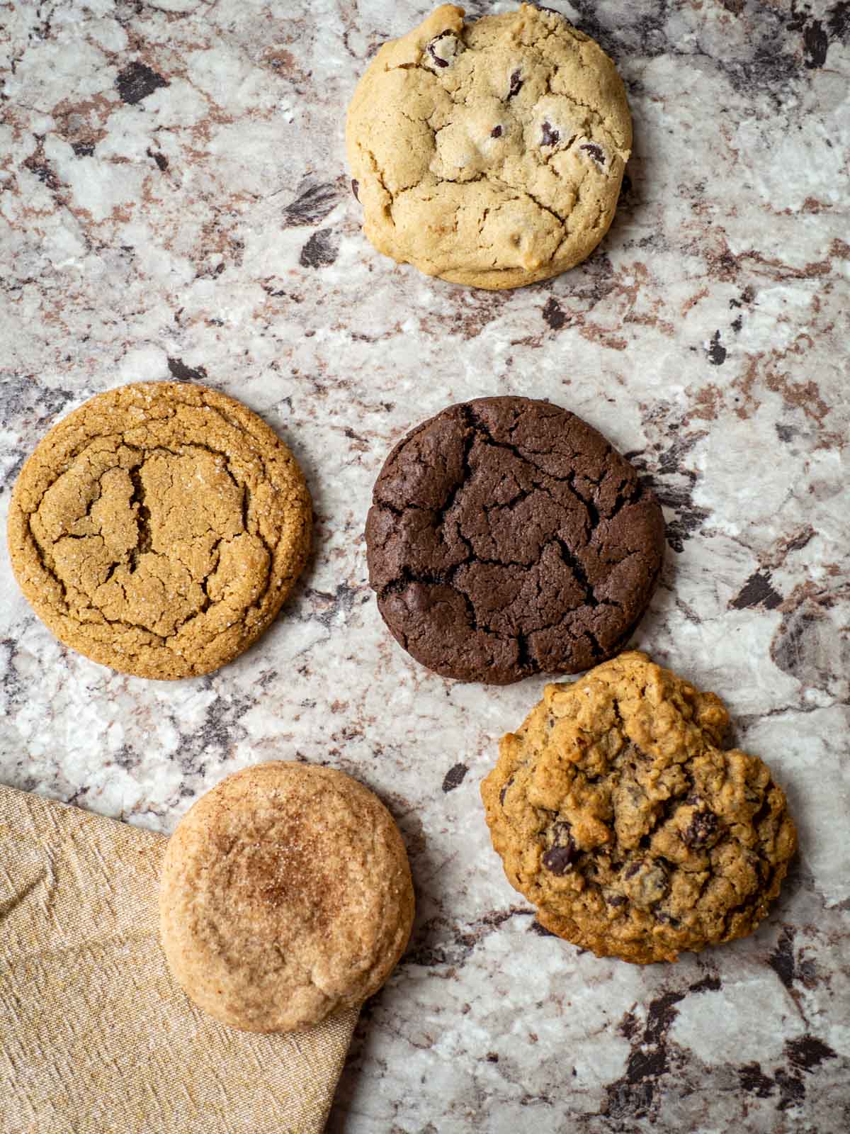 5 oat flour cookies spread out on a countertop.