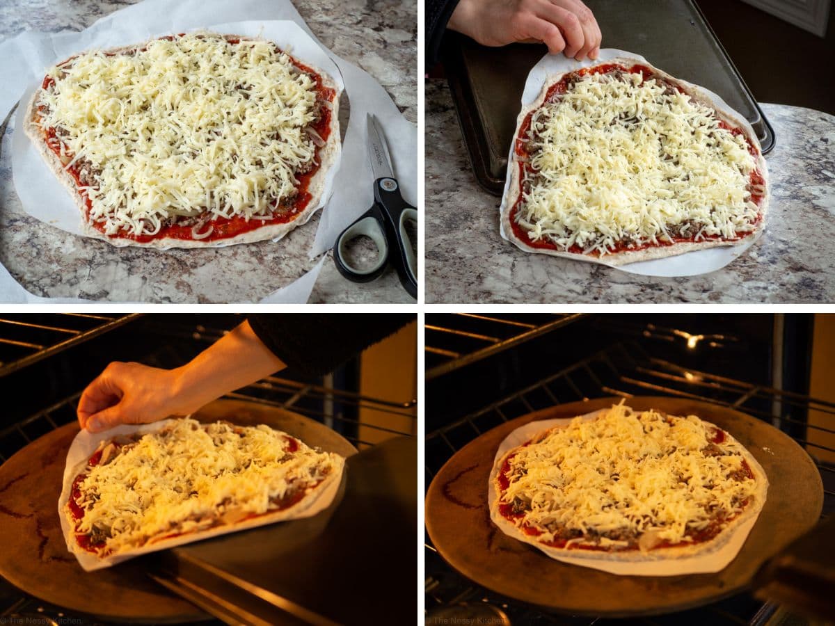 A prepared pizza on parchment paper being transferred to a heated pizza stone.